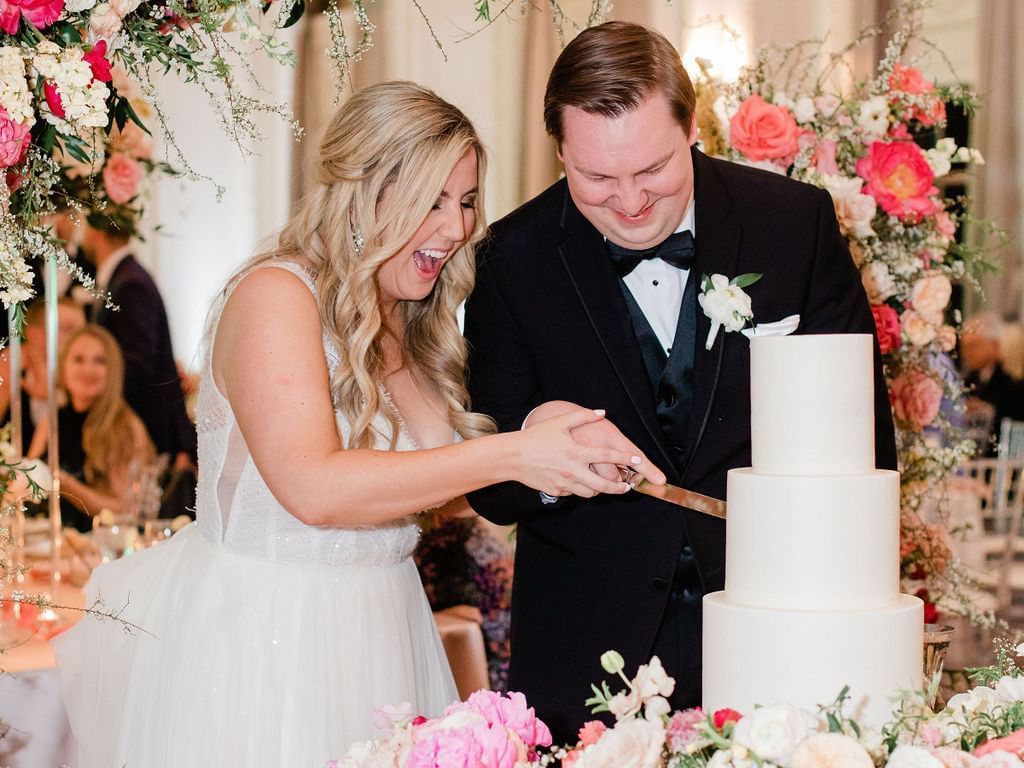 Wedded couple cutting a cake at their reception, The Mayo Hotel