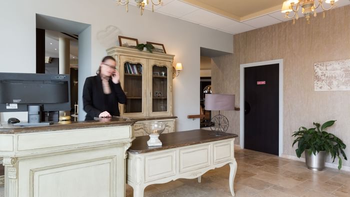 A receptionist at the reception in Hotel Les Poemes de Chartres
