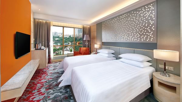 Bright Deluxe Park Twin Room at Sunway Hotel Pyramid, featuring two beds, a balcony, and city views.