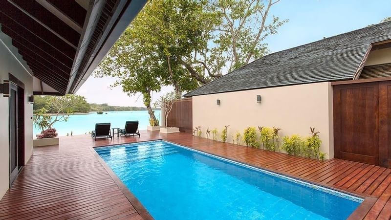 Pacific Pool Villa featuring a rectangular lap pool on a wooden terrace with ocean view at warwick le lagon-vanuatu