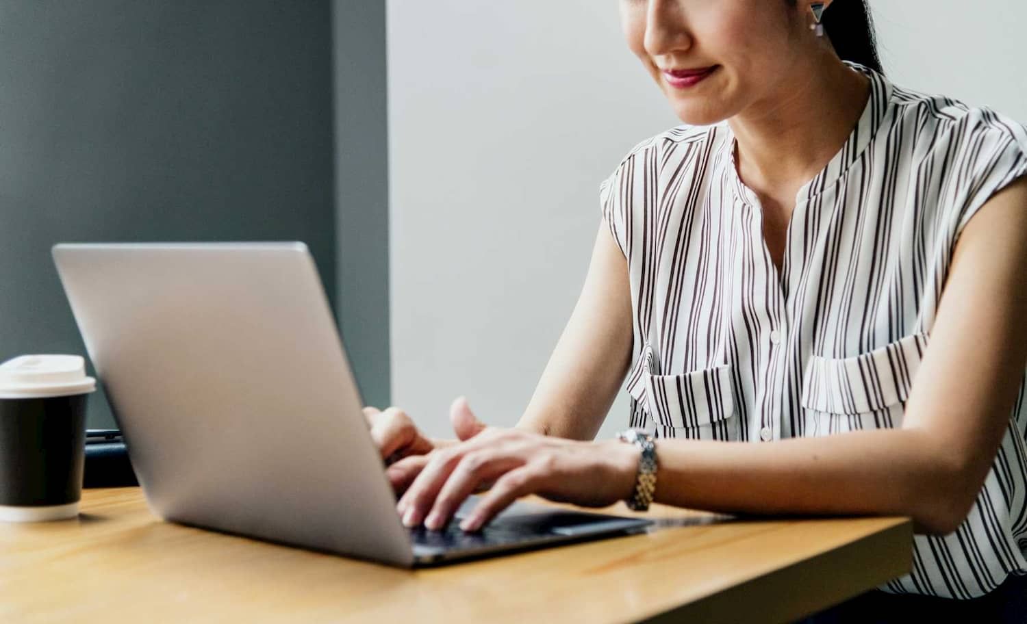 A woman checking hotel review with her laptop