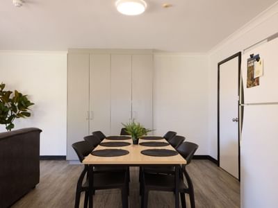 Dining area with table, chairs, and refrigerator at UniLodge at Curtin University - Vickery House.