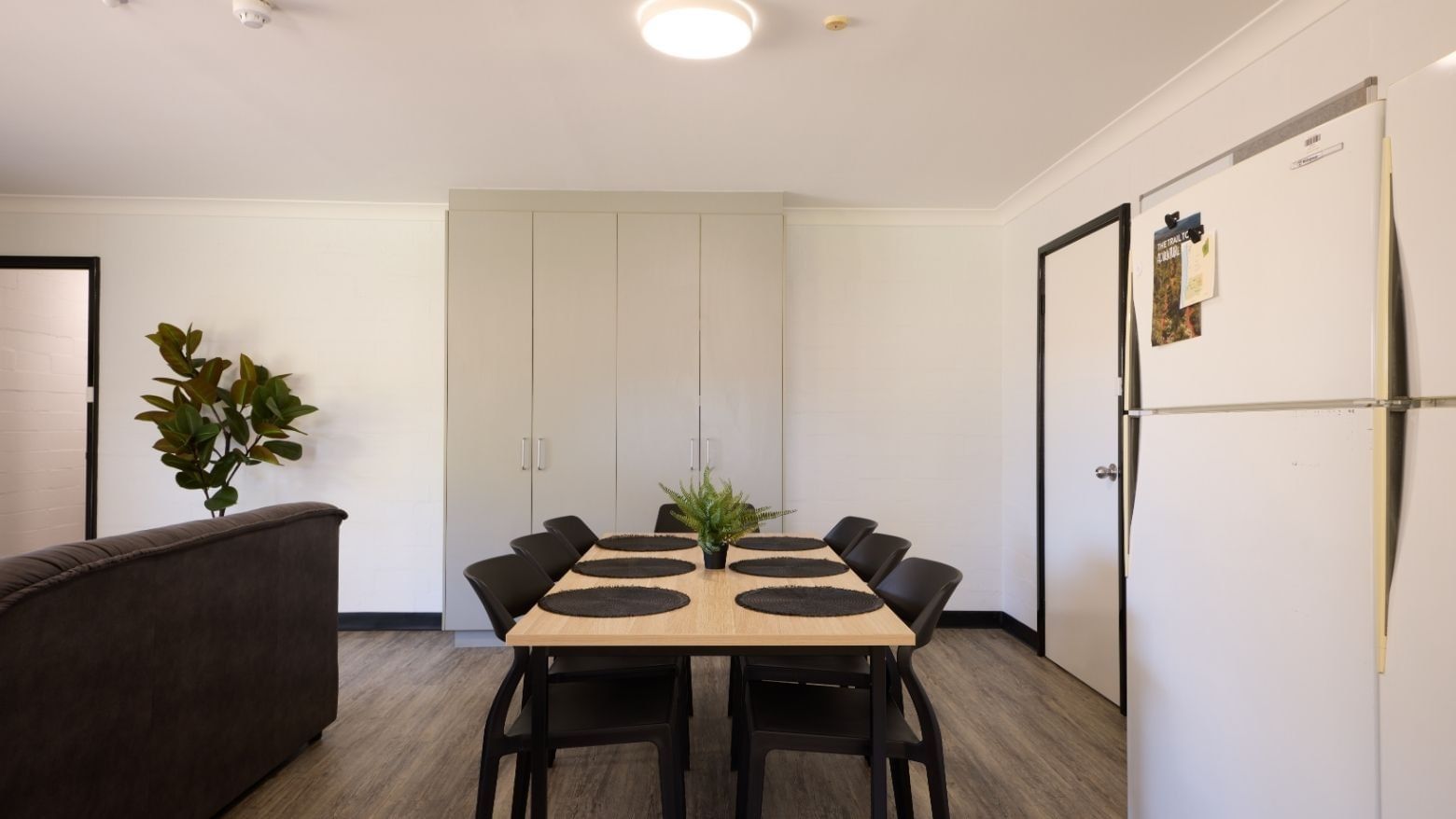 Dining area with table, chairs, and refrigerator at UniLodge at Curtin University - Vickery House.