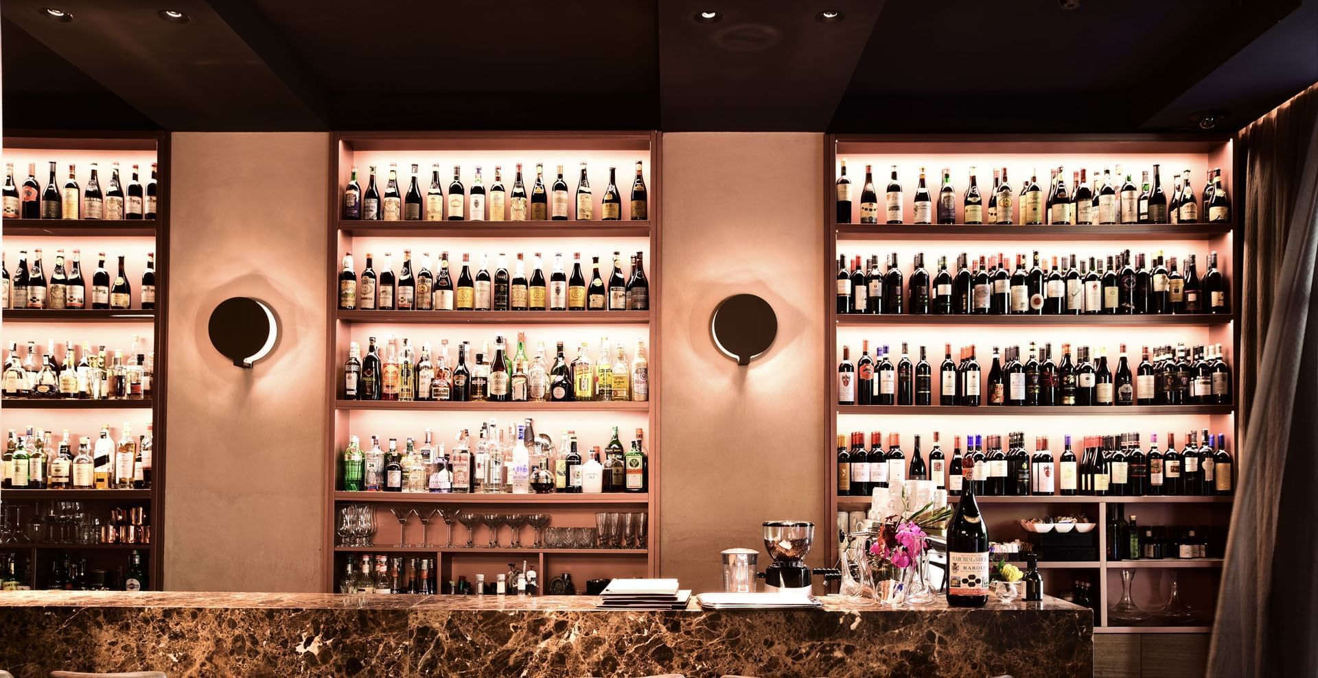 Wine bottles are neatly arranged on shelves in EMME Restaurant at Margutta 19