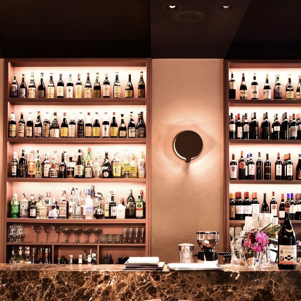 Wine bottles are neatly arranged on shelves in EMME Restaurant at Margutta 19