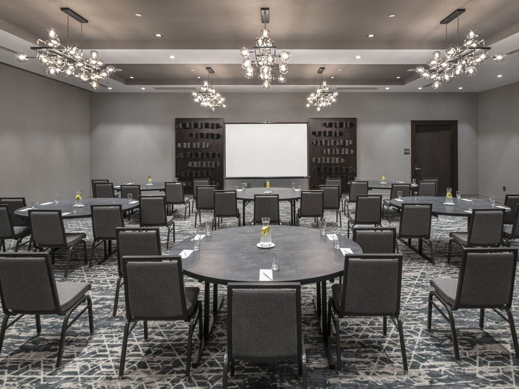 chairs and tables facing a projector screen