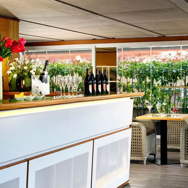 Liquor bottles arranged with glasses  on the bar counter of Babuino Terrace at Babuino 181