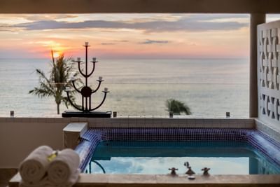 Private terrace jacuzzi overlooking a spectacular tropical ocean sunset at the boutique resort.