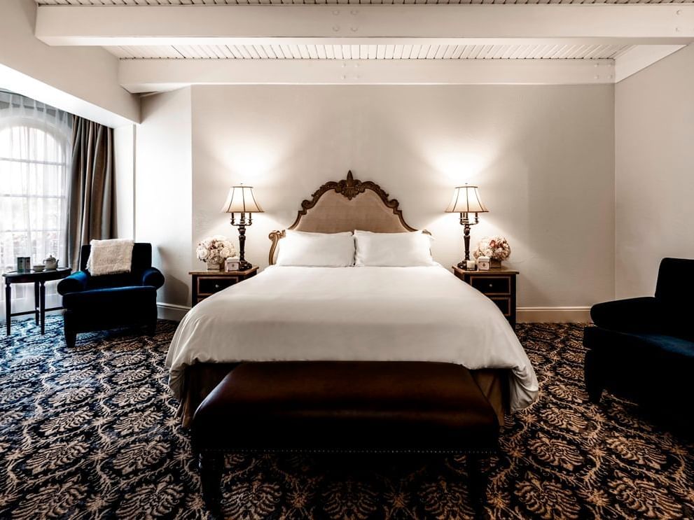 room with large bed, nighstands and accent chair