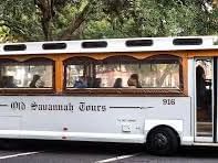 White bus with passengers for Old Savannah Tours at River Street Inn