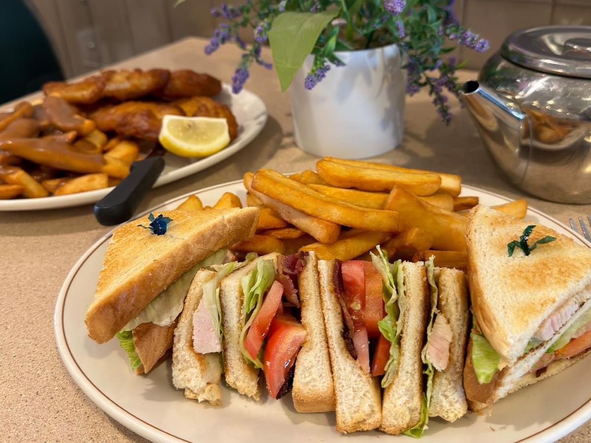 a sandwich served with fries at Green Gables Restaurant & Lounge