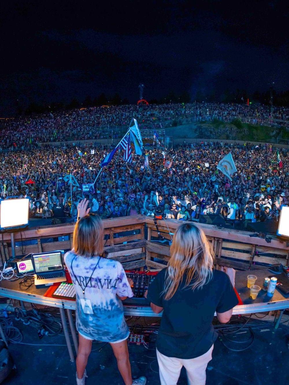 DJs performing at an outdoor festival with a large crowd at night for Backstage City Stay offer.