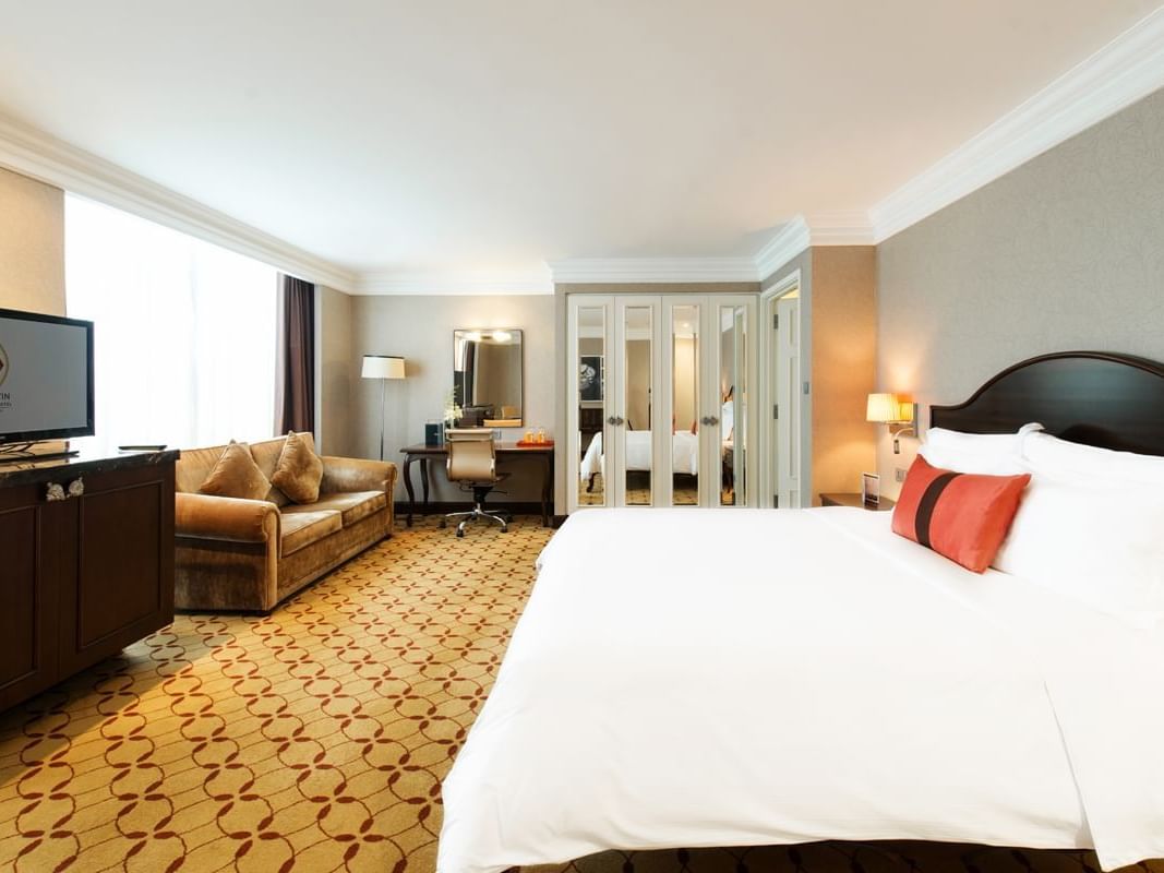 White sheeted bed in Deluxe Family Room at Eastin Hotels