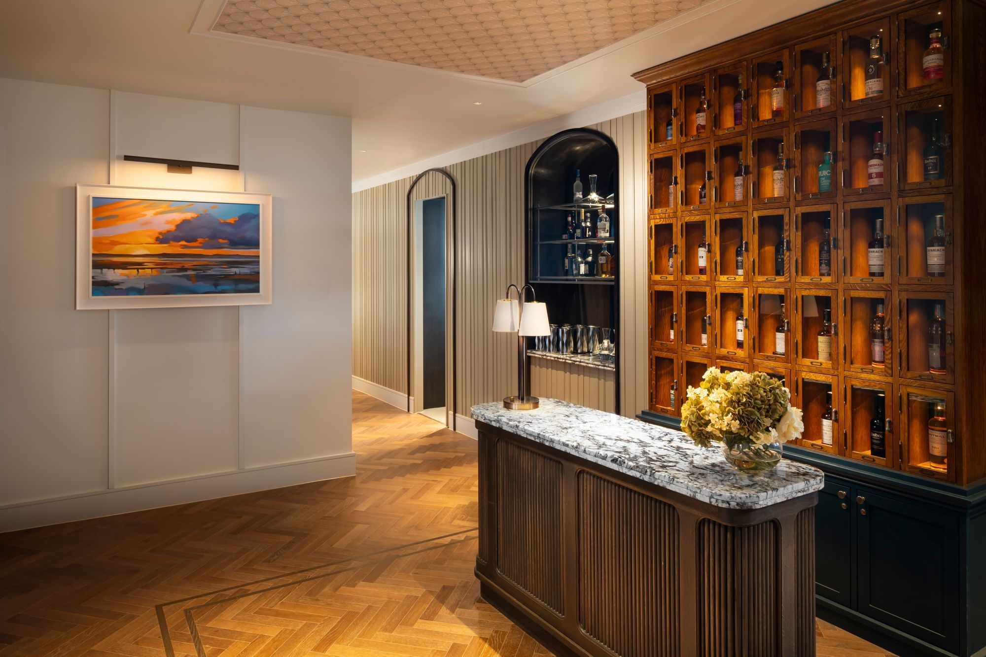 Ondine Oyster & Grill with a marble counter, a wooden liquor cabinet, and a painting of a sunset at Seaton House
