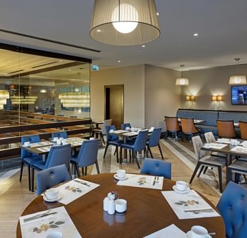 Dining area with lobby view in Alesta Restaurant at Titanic City Taksim.