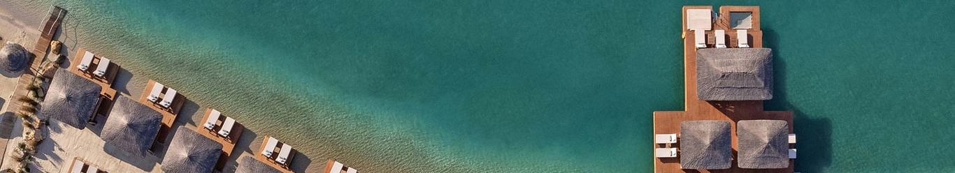 Overhead view of beach cabanas and sun loungers at Titanic Luxury Collection Bodrum