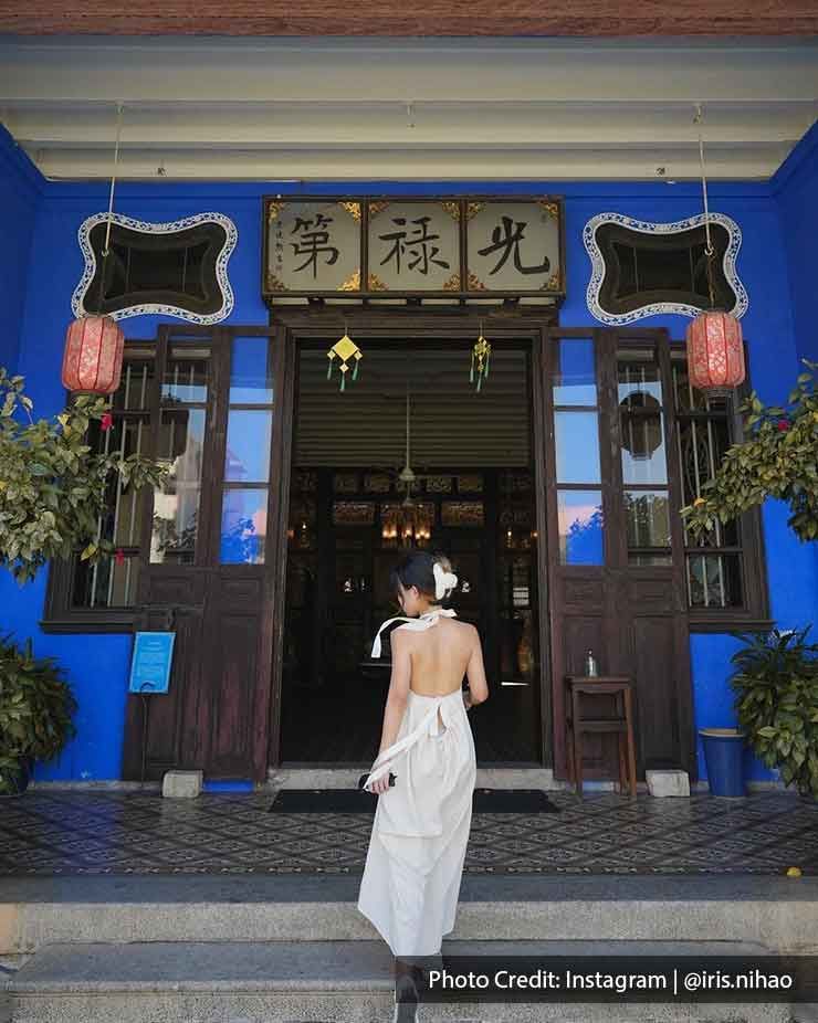 A woman stood at the front door of the Cheong Fatt Tze Mansion - Lexis Suites Penang