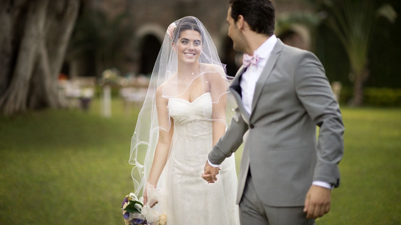 Wedding couple walking in the garden at Fiesta Americana Hotels