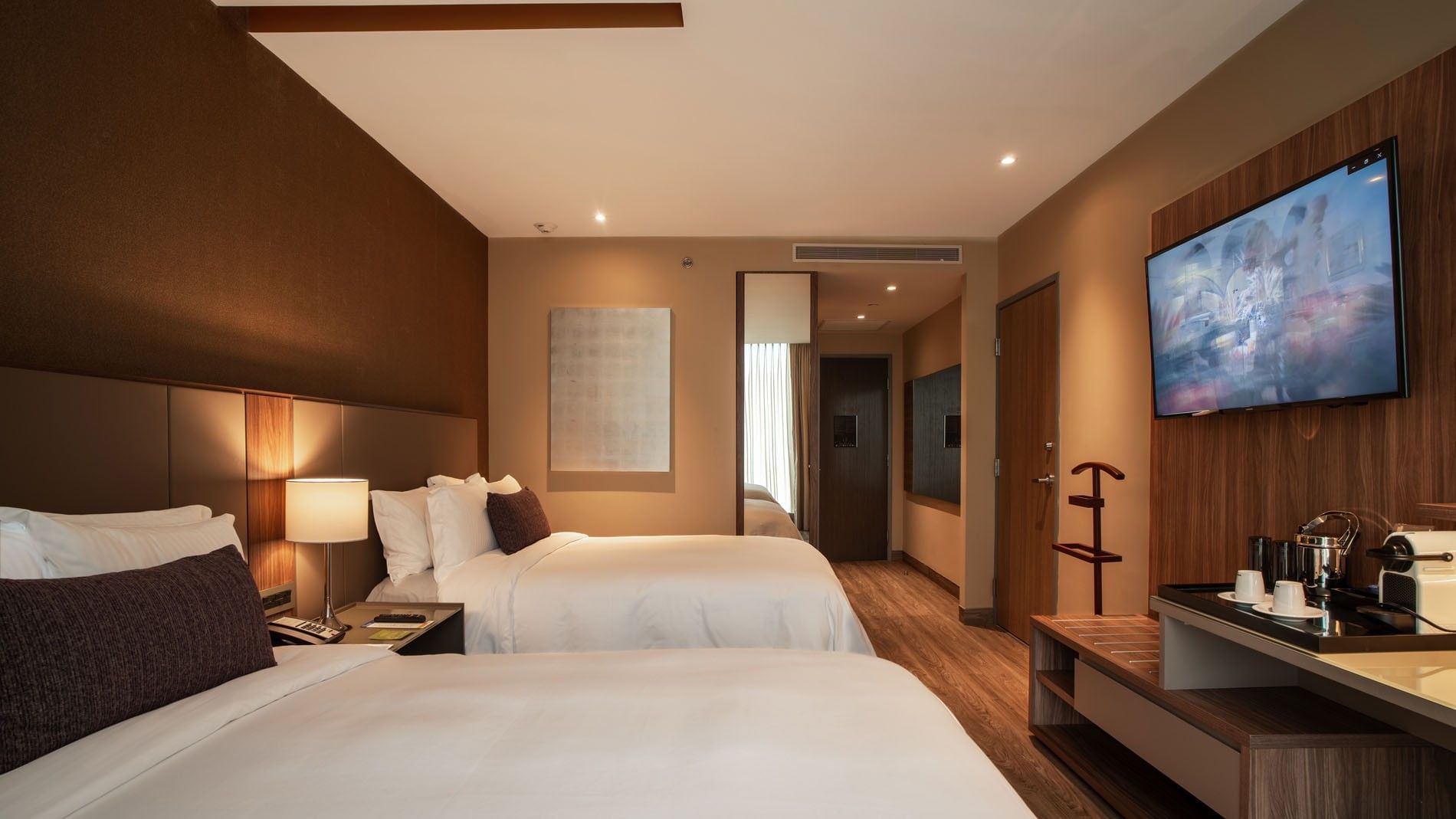 2 Double Deluxe with two beds, a wall-mounted TV, & a hallway leading at Camino Real Fashion Drive, Monterrey