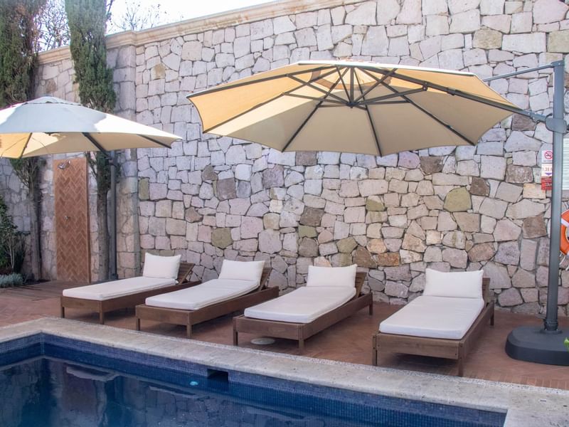 Sunbeds by the outdoor pool at Gamma Morelia Vista Bella