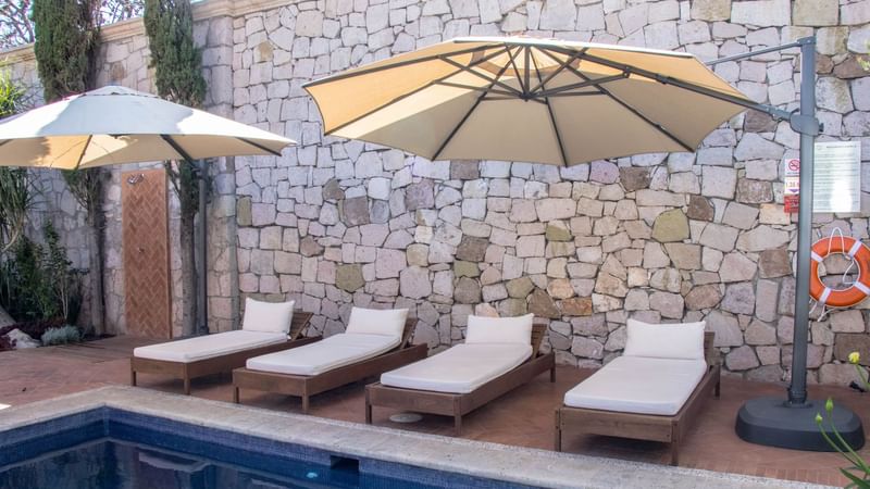 Sunbeds by the outdoor pool at Gamma Morelia Vista Bella