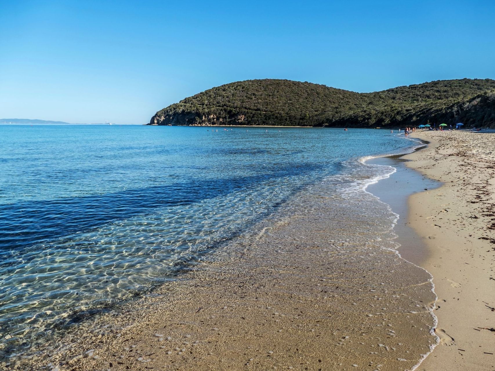 Landscape view of Cala Violina beach & mountains near Golf Hotel Punta Ala