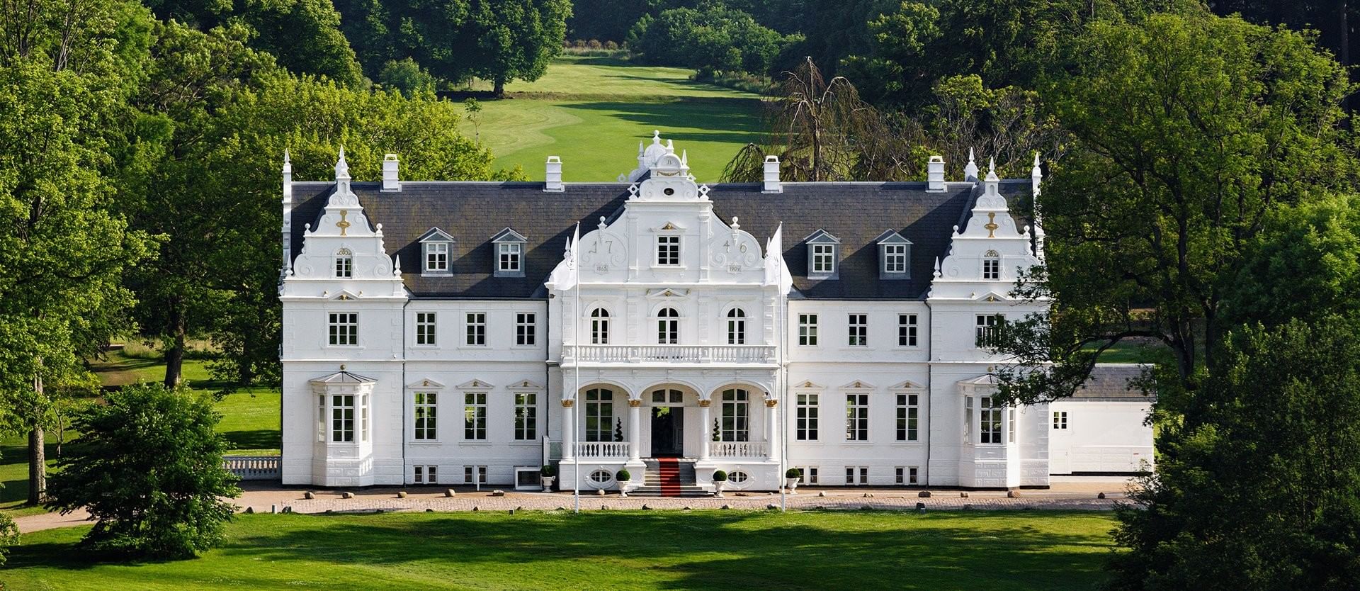 Warwick Denmark hotel exterior with symmetrical windows and green lawn at Warwick Denmark