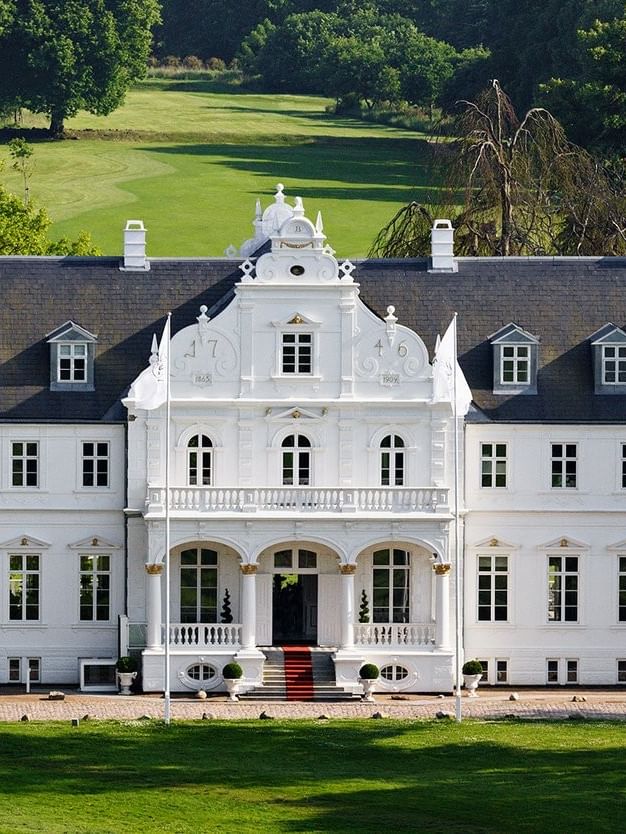 Warwick Denmark hotel exterior with symmetrical windows and green lawn