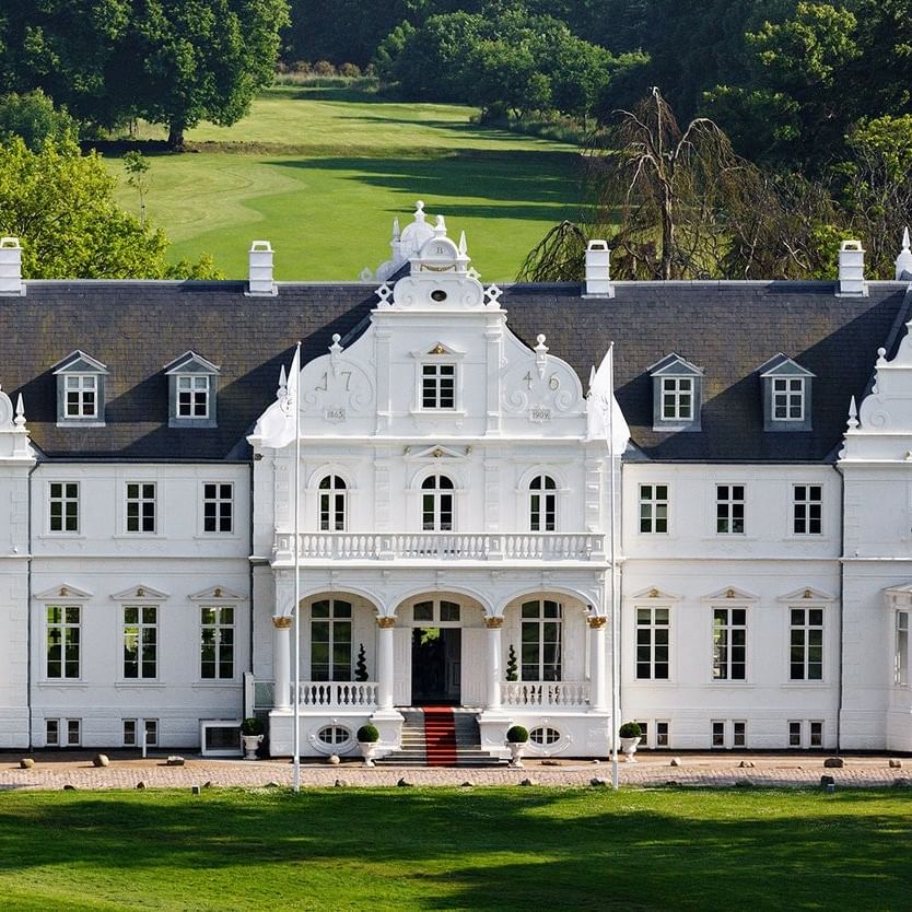 Warwick Denmark hotel exterior with symmetrical windows and green lawn