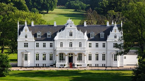 Warwick Denmark hotel exterior with symmetrical windows and green lawn