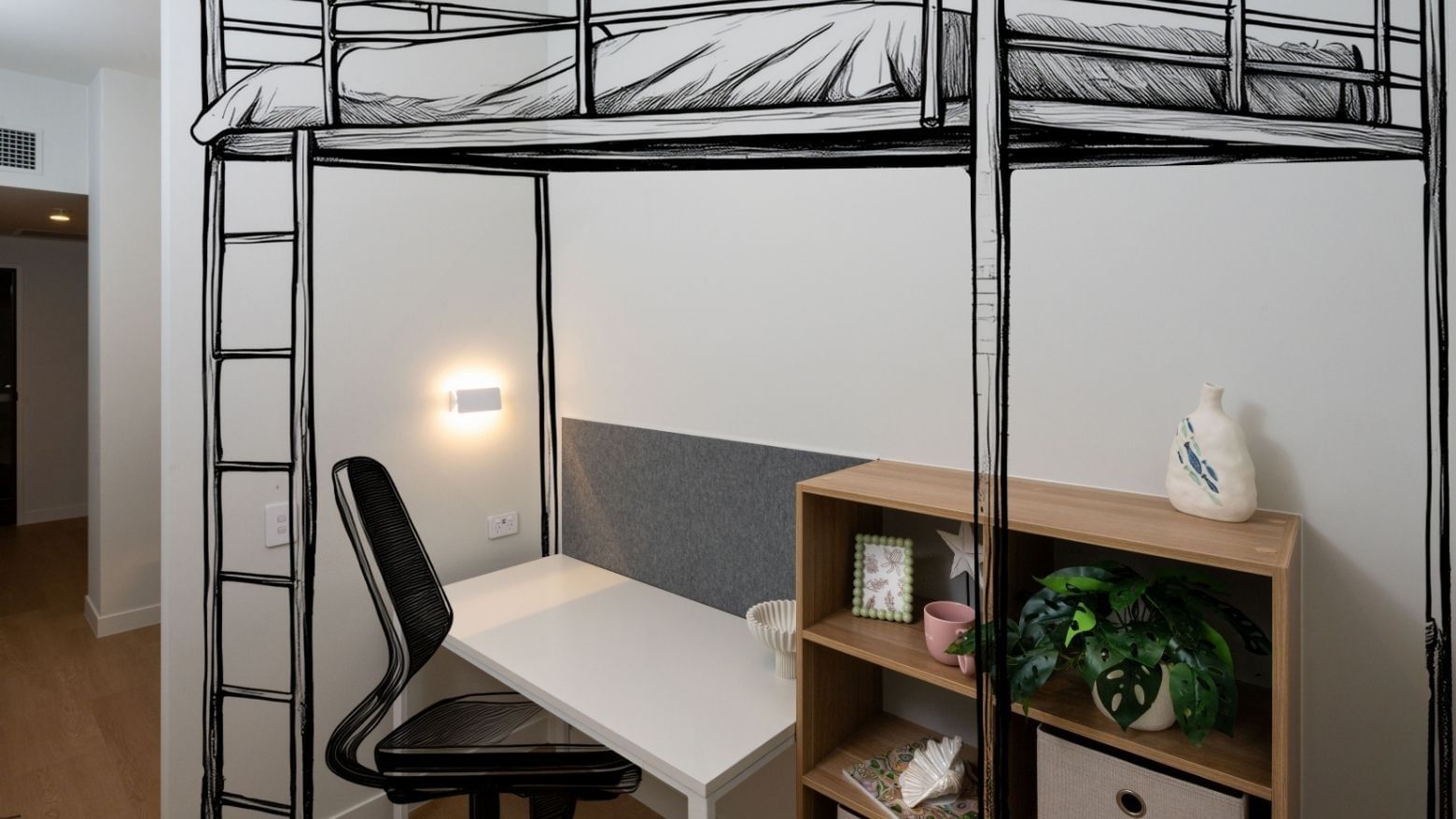 Bunk bed, desk, chair, and bookshelf in a room at UniLodge Brisbane City.