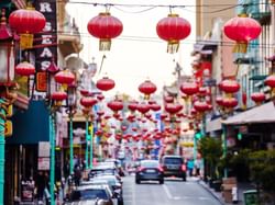 Ethnic neighborhood of Chinatown with red lanterns hung over the streets near Hotel Julian San Francisco