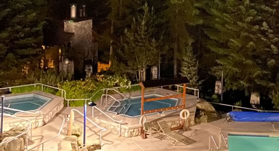 Night view of pool area with hot tubs and swimming pool at Blackcomb Springs Suites