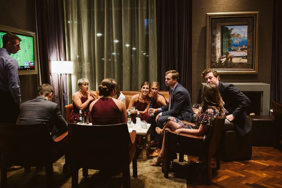 a group of men and women sitting in a lobby area