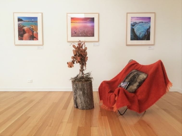 Room with a chair and sceneries at Cradle Mountain Hotel