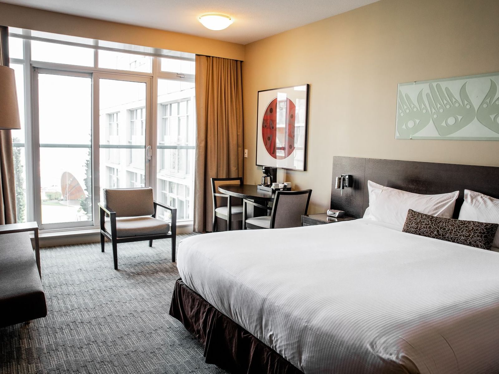 a bed and chairs in a hotel room