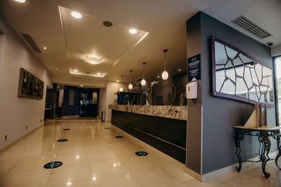Hallway by the lobby reception area at Araiza Hotel Calafia