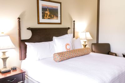 king bed and pillow with the letter C on it