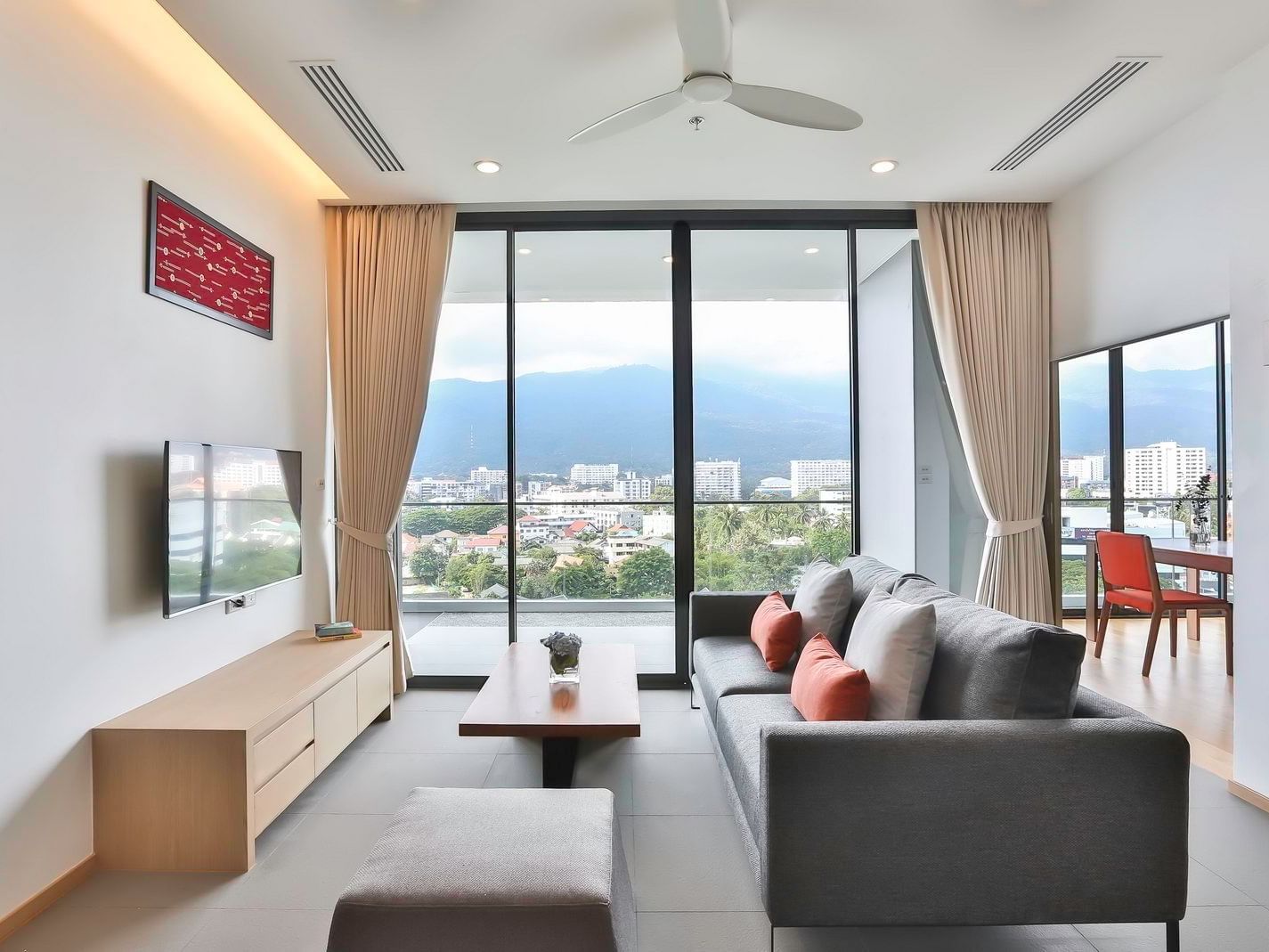 Living room of Two-Bedroom Suite with TV & sofa at Eastin Tan Hotel Chiang Mai