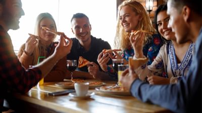 Bunch of friends having pizza together at Sunseeker Resort