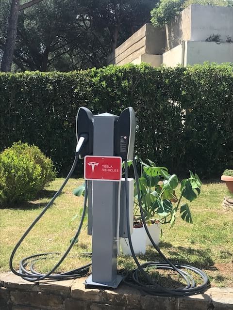 Tesla car charger in the car park at Golf Hotel Punta Ala