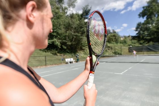 Two people playing tennis at Topnotch Stowe Resort
