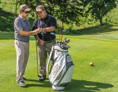 Close-up of 2 golfers at the Chatrium Resort's golf course
