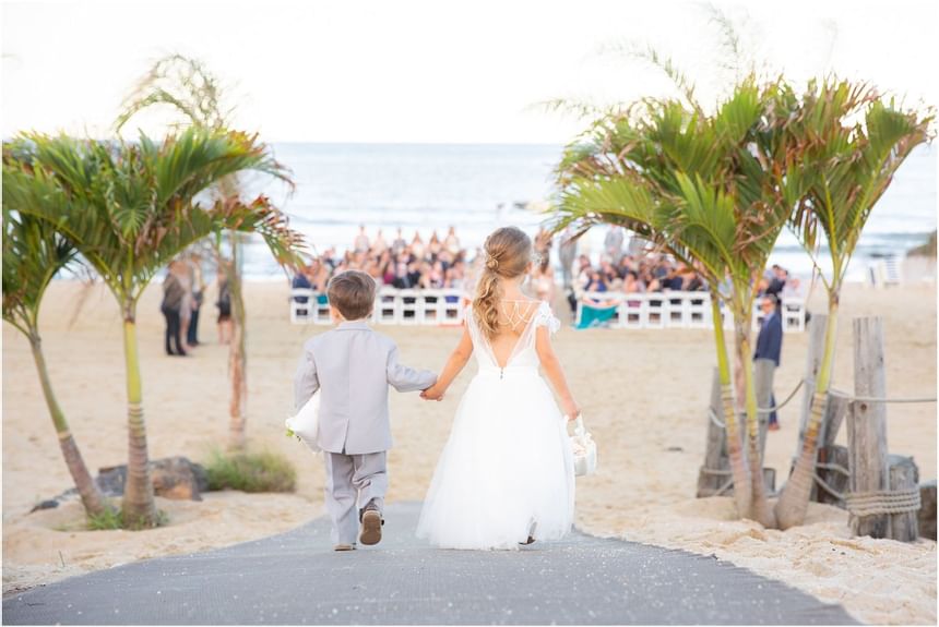 Flower boy & Girl walking in an outdoor wedding at Ocean Place
