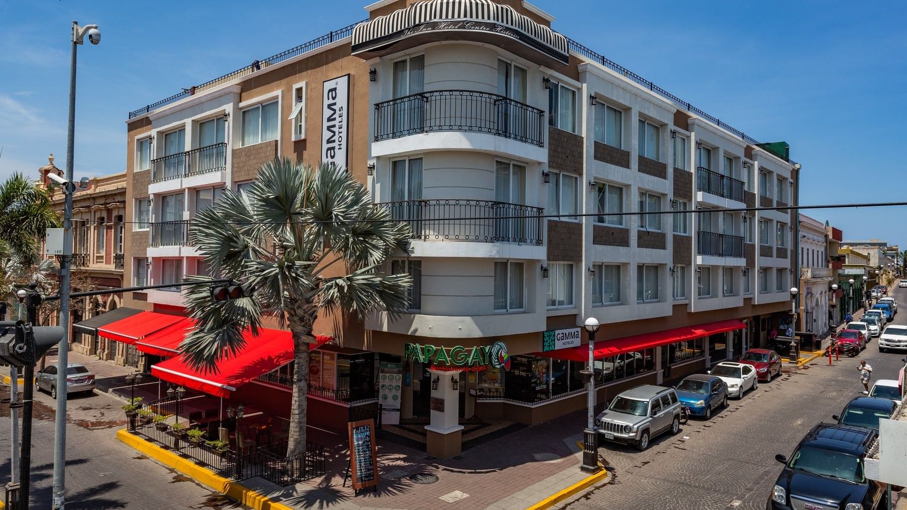 An exterior view of the hotel & street at Gamma Hotels