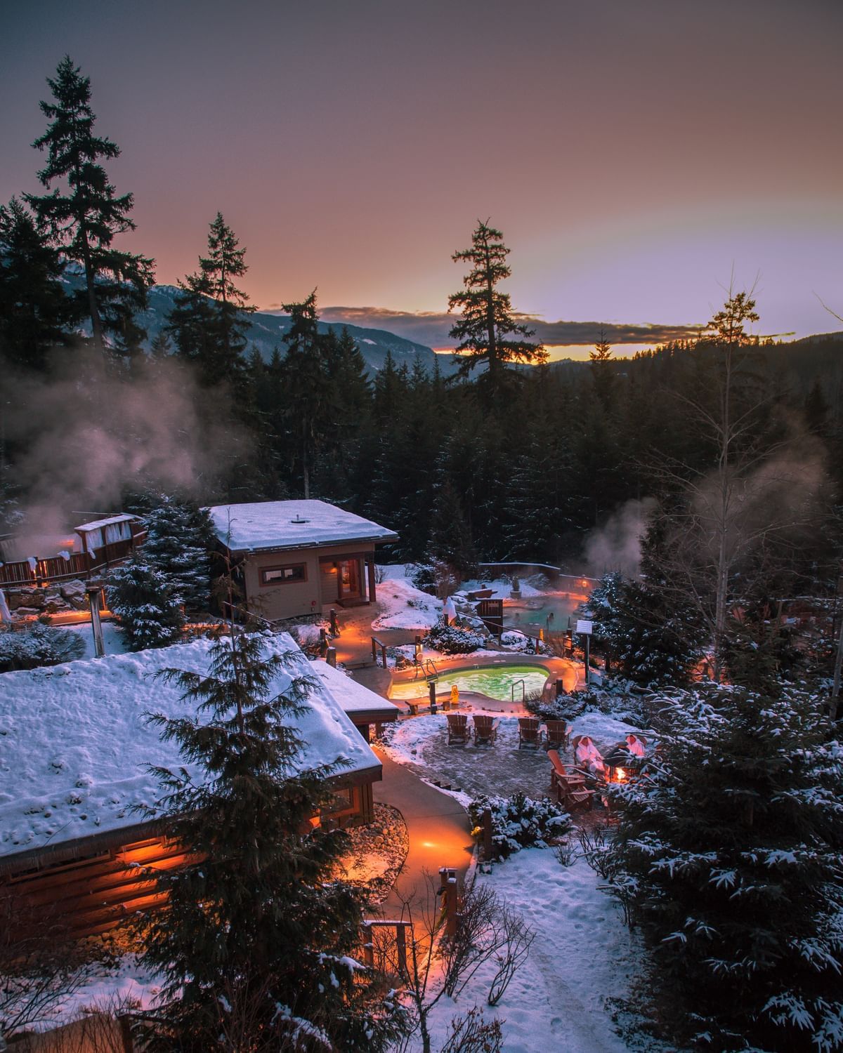 Aerial view of  snow-covered Scandinave Spa near Blackcomb Springs Suites