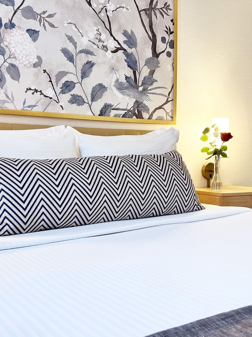King Room with white bedding and artistic wall decor at Warwick Allerton Chicago