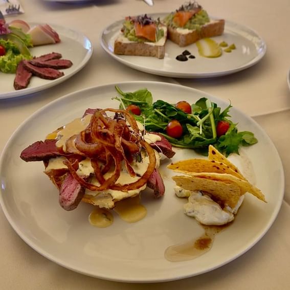 Various cuisines served on plates at Diez Hotel Categoría