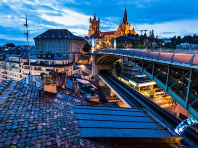 Twilight cityscape of Lausanne Cathedral, places to see in Lausanne near Starling Hotel Lausanne