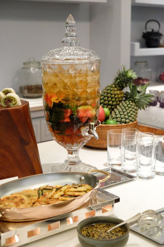 Crystal beverage dispenser filled with iced fruit-infused drink, surrounded by fresh fruits at Park Hyatt Saigon